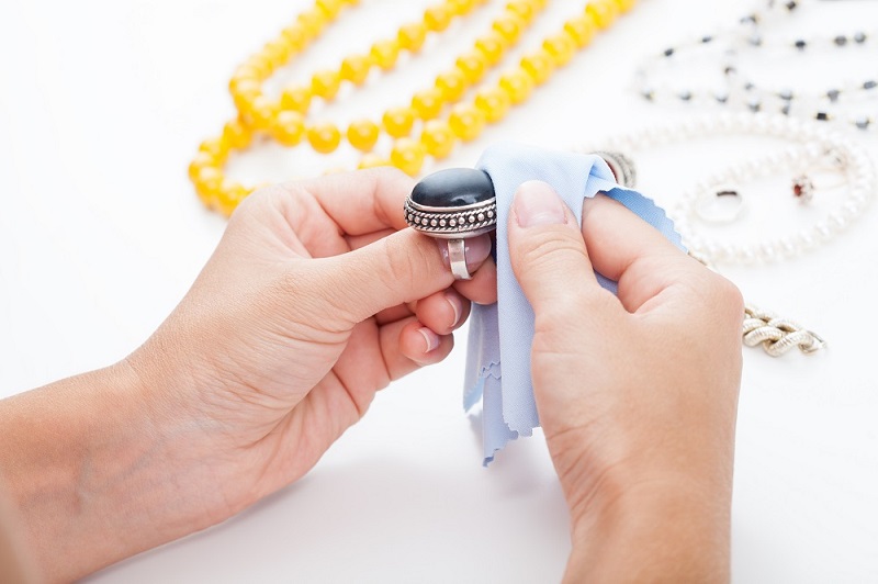 Polishing silver jewellery with a cloth